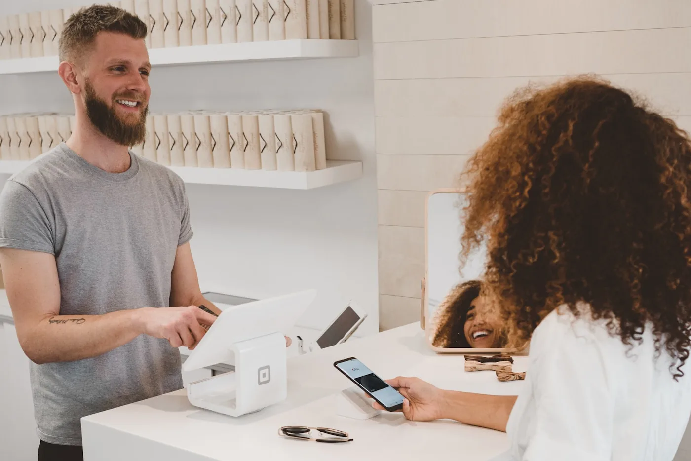 Shopper with phone and bags — order status and returns answered without brittle scripts