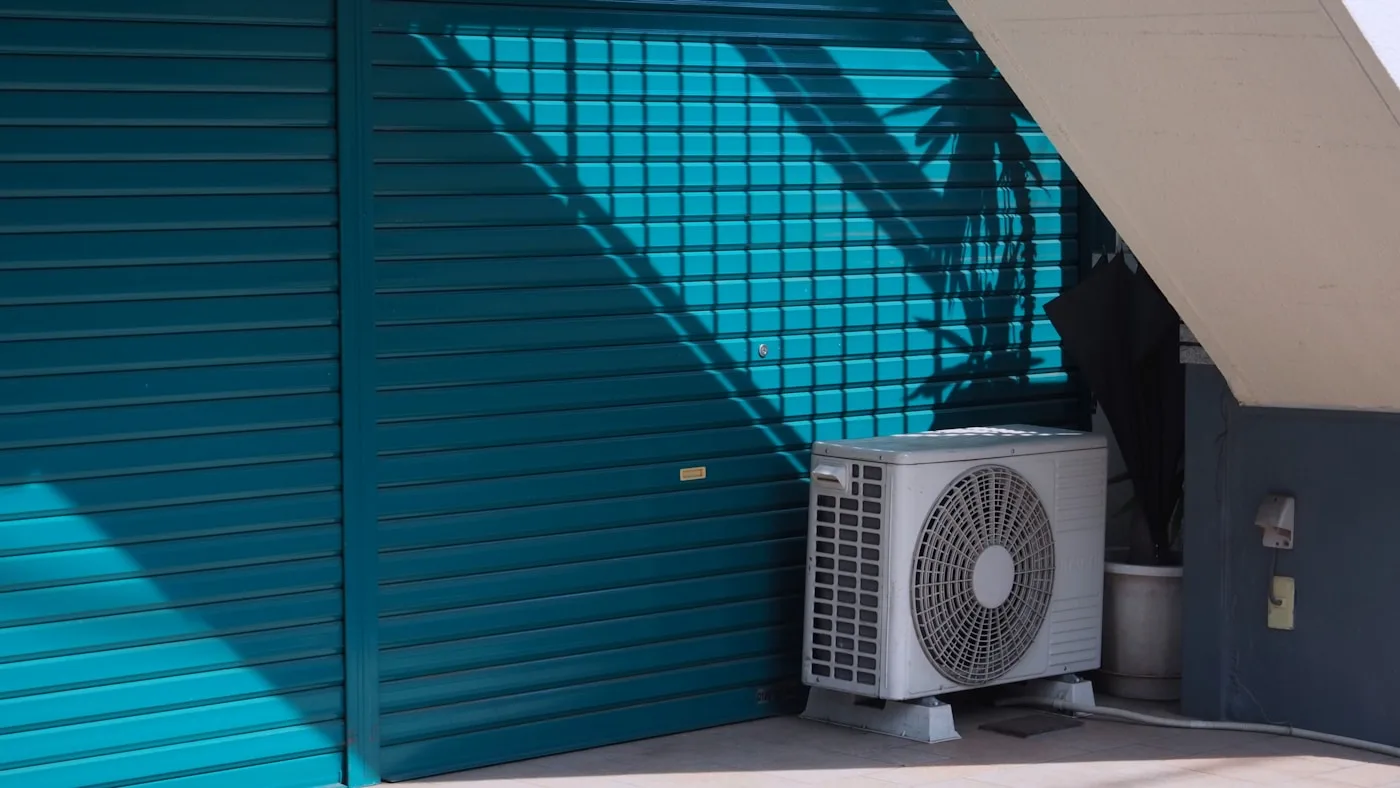 Residential air conditioner outside a home — the unit homeowners call about when heat or AC fails