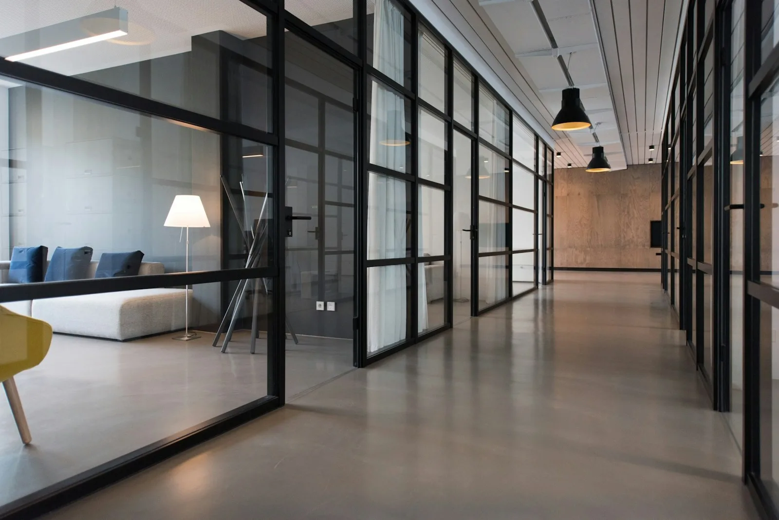 Open-plan office with floor-to-ceiling windows and natural daylight